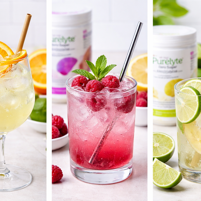 Three zero-sugar electrolyte mocktails—citrus spritz, berry fizz, and ginger lime—served with ice and fresh fruit garnishes.