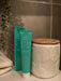 Flossy & Pure Mild Mint toothpaste tube and box in a bathroom setting