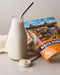 Power Super Foods maca powder pictured with a smoothie and a spoon of powder