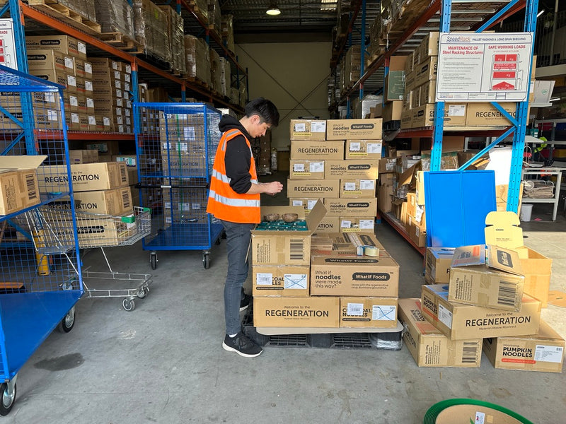 A BuyNatural team member handling stock in the warehouse